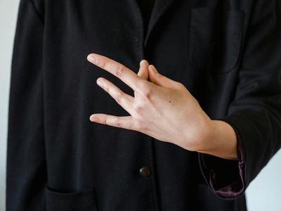 Close up of hands in a mudra position.