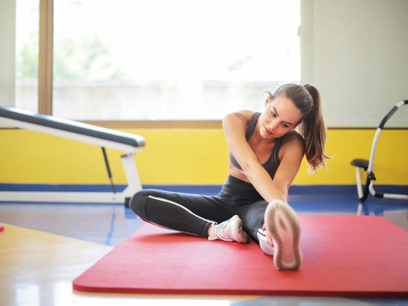 Detailed view of yoga equipment and a person in a stretch.