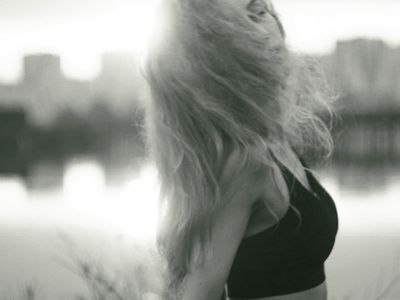 Side stretch pose in silhouette against magenta light.